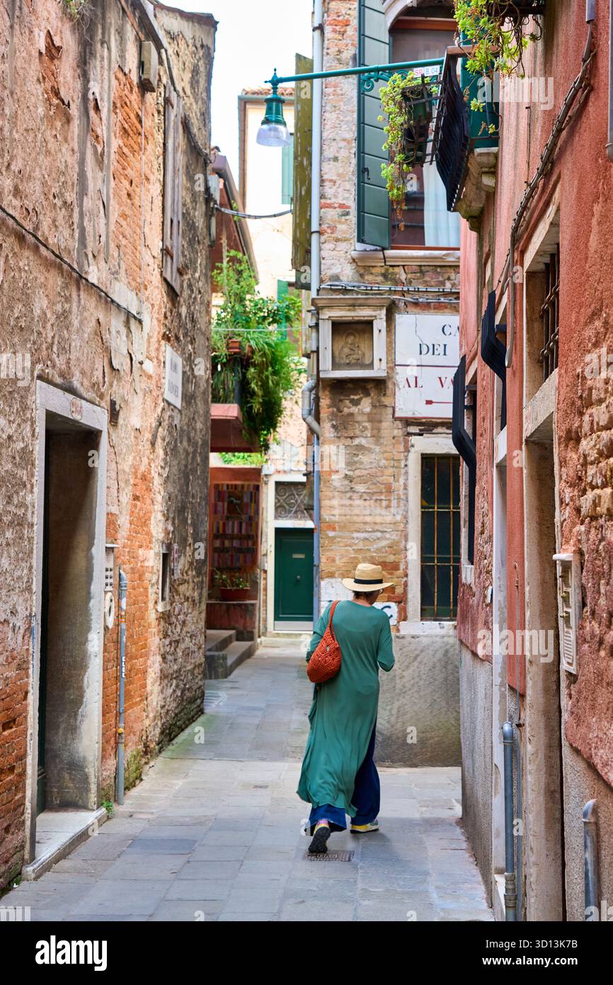 Woman with a hat walking down the street, Venice, Venezia, Veneto, Italy, Europe Stock Photo