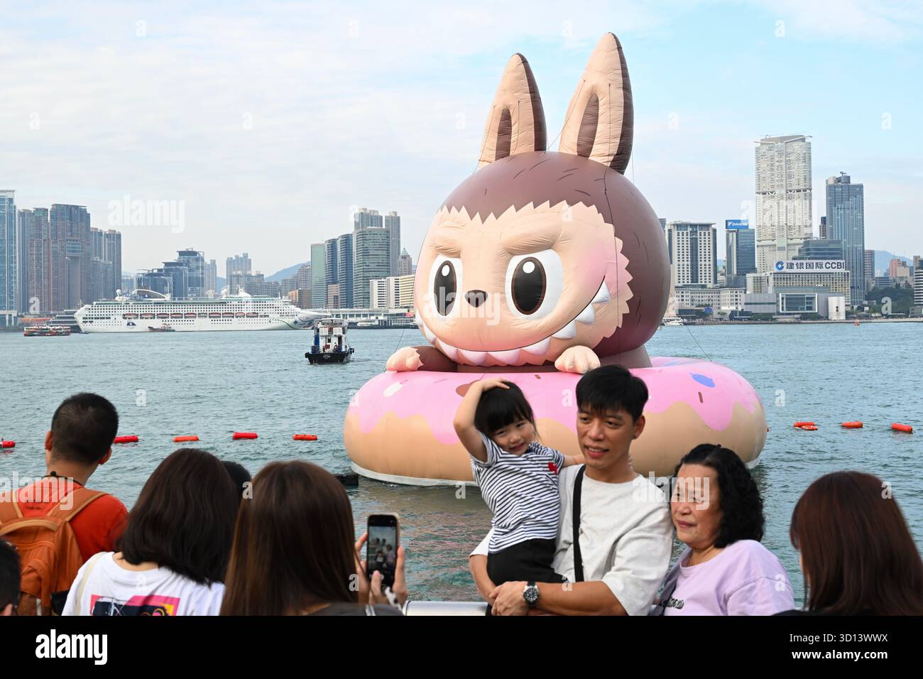 Labubu Inflatable People taking photo with Labubu, a floating inflatable sculpture at the ...