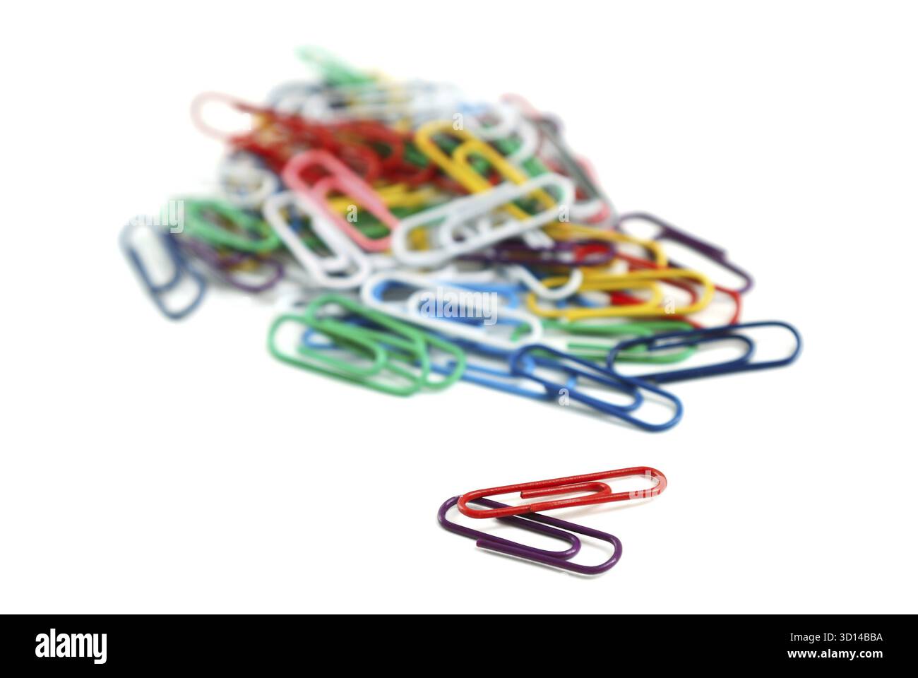 Colored paper clips on a white background Stock Photo