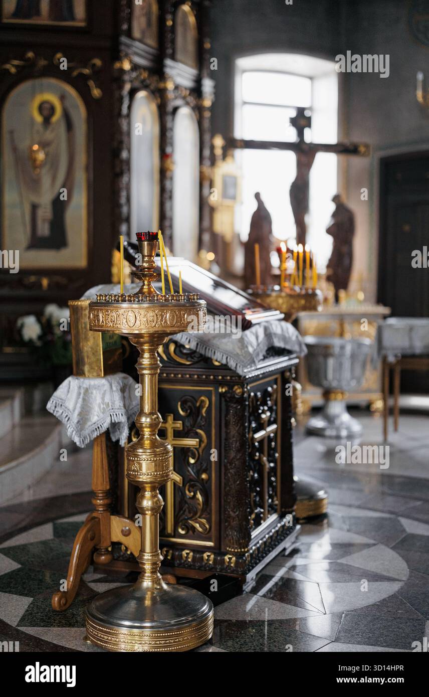 Interior of an Orthodox church with gold candlestick, burning candles ...