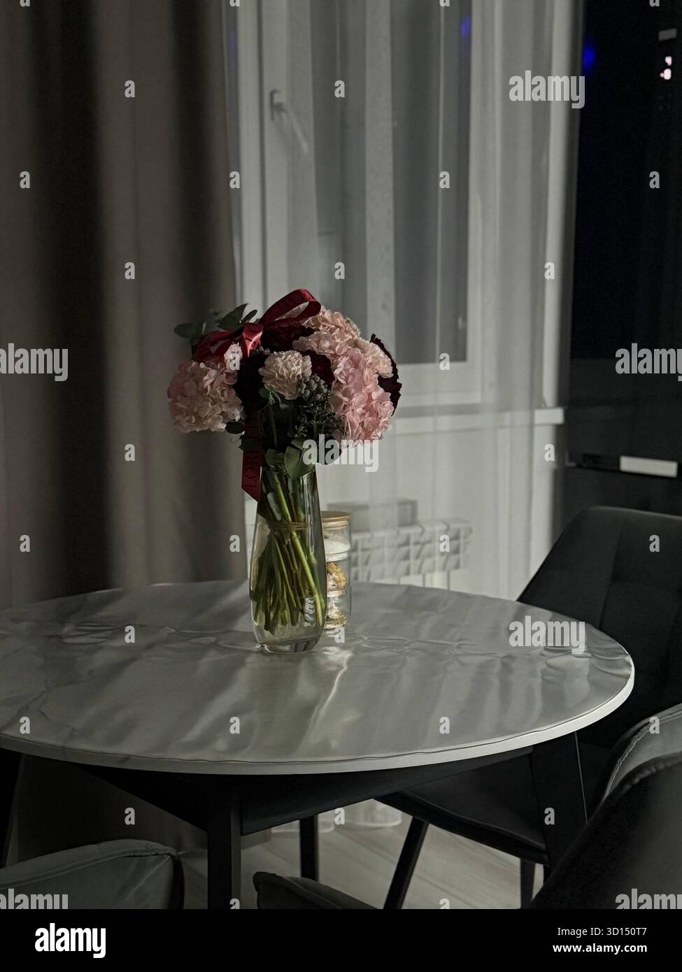 Cozy kitchen with flowers at night - Smartphone Captured Stock Image