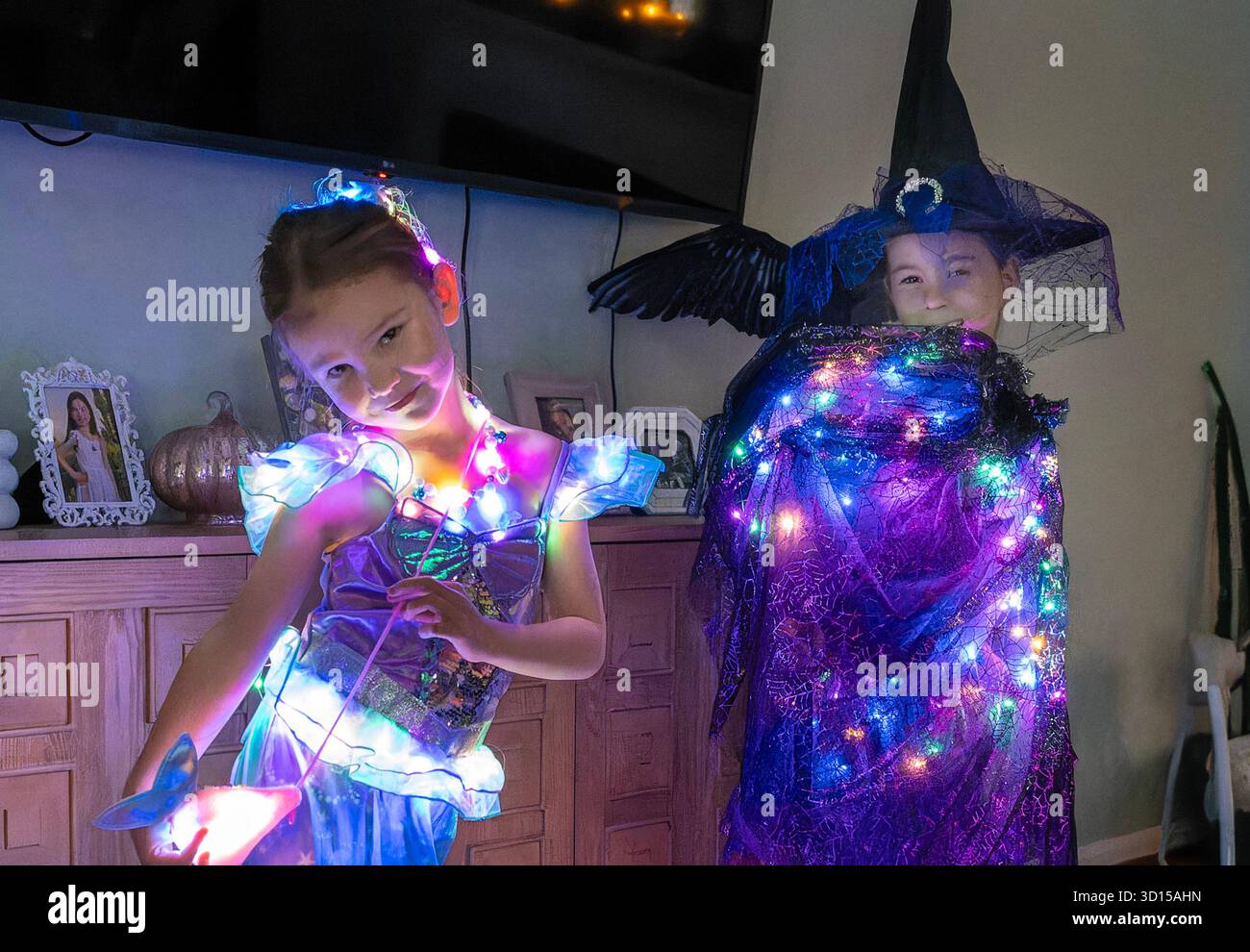 Children pose in lighted halloween costumes Stock Photo