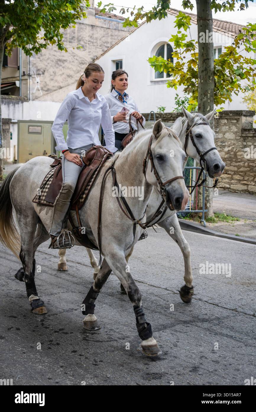 Mother and daughter riding in the procession of the Guardians at San Remy de Provence, France. Stock Photo