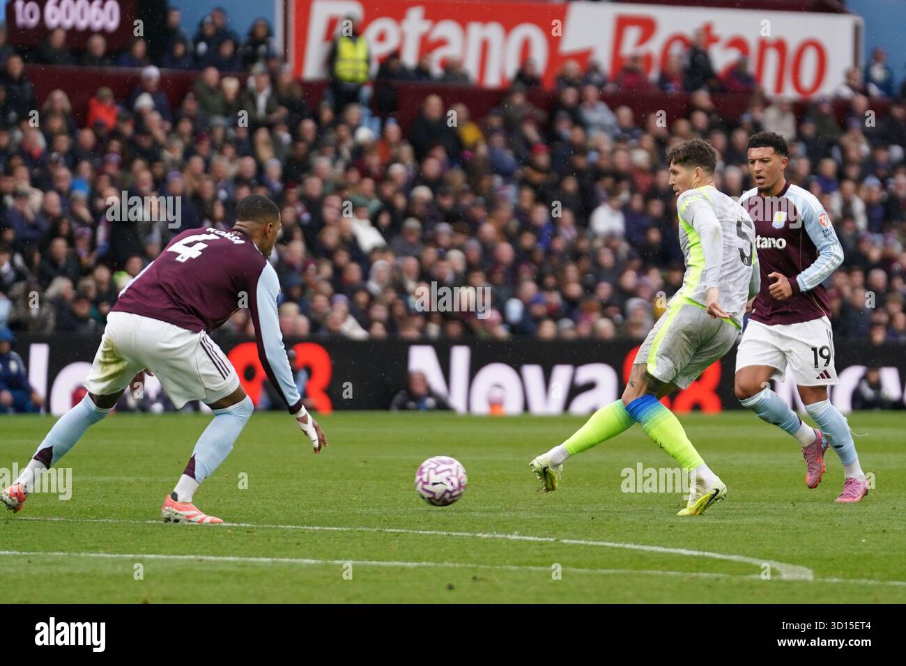 John Stones of Manchester City under pressure from Ezri Konsa of Aston ...