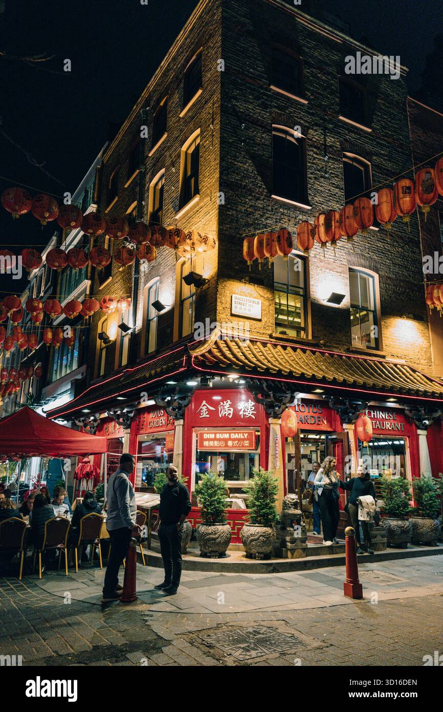Restaurants and Chinese lanterns in Chinatown at night, London, England Stock Photo