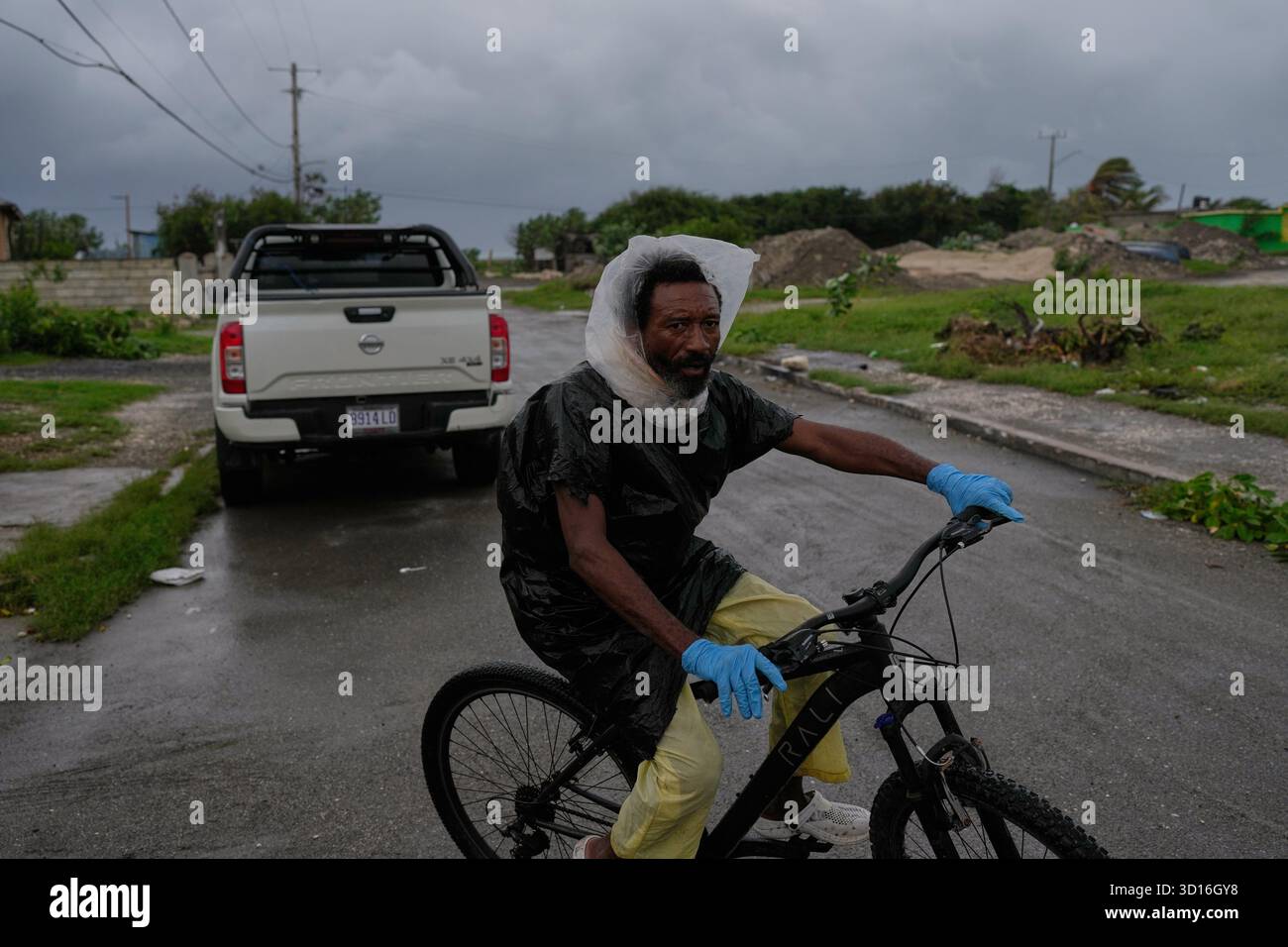 A Man Rides A Bicycle Ahead Of The Forecast Arrival Of Hurricane a-man-rides-a-bicycle-ahead-of-the-forecast-arrival-of-hurricane