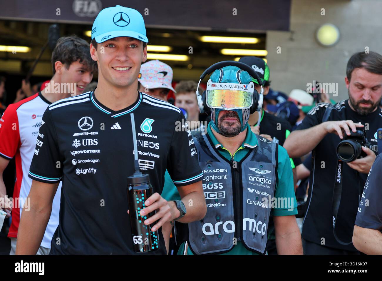 (L to R): George Russell (GBR) Mercedes AMG F1 with Fernando Alonso ...