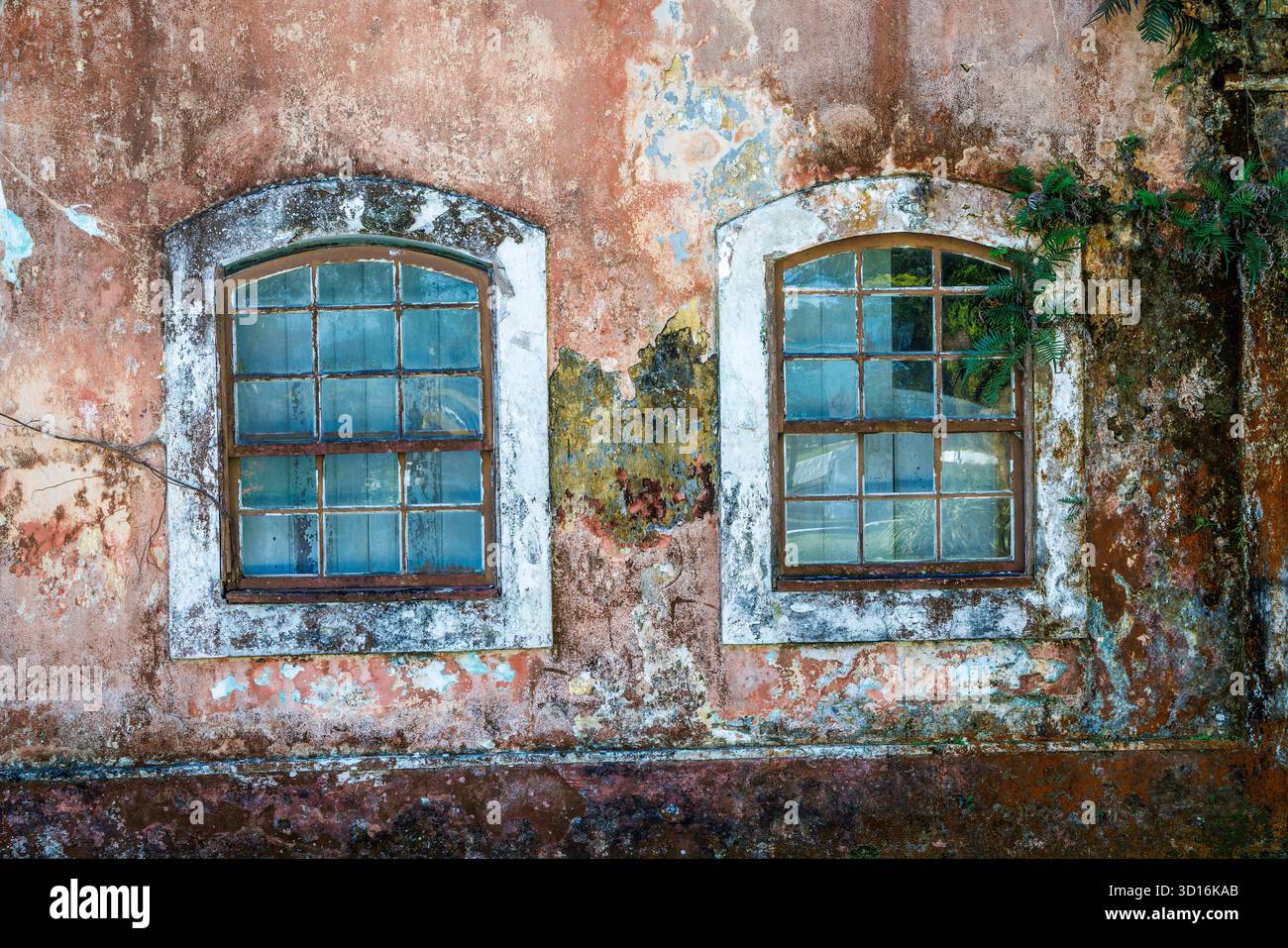 House with shuttered windows and fading paintwork, Cananeia, Brazil Stock Photo