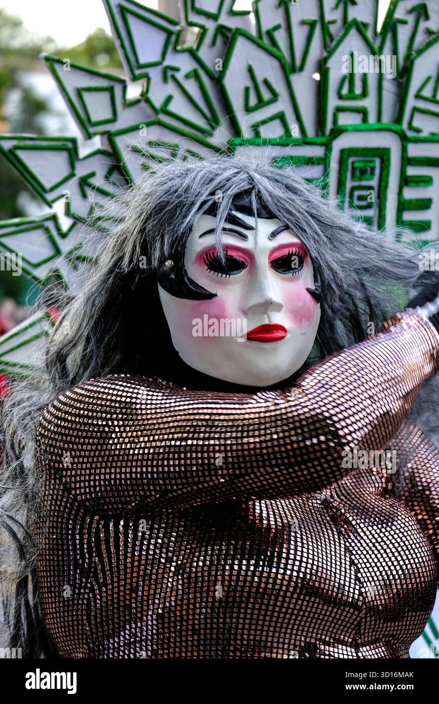 Person in elaborate costume and theatrical mask with bold makeup performing during the Xantolo (Day of the Dead) parade in San Luis Potosi, Mexico Stock Photo
