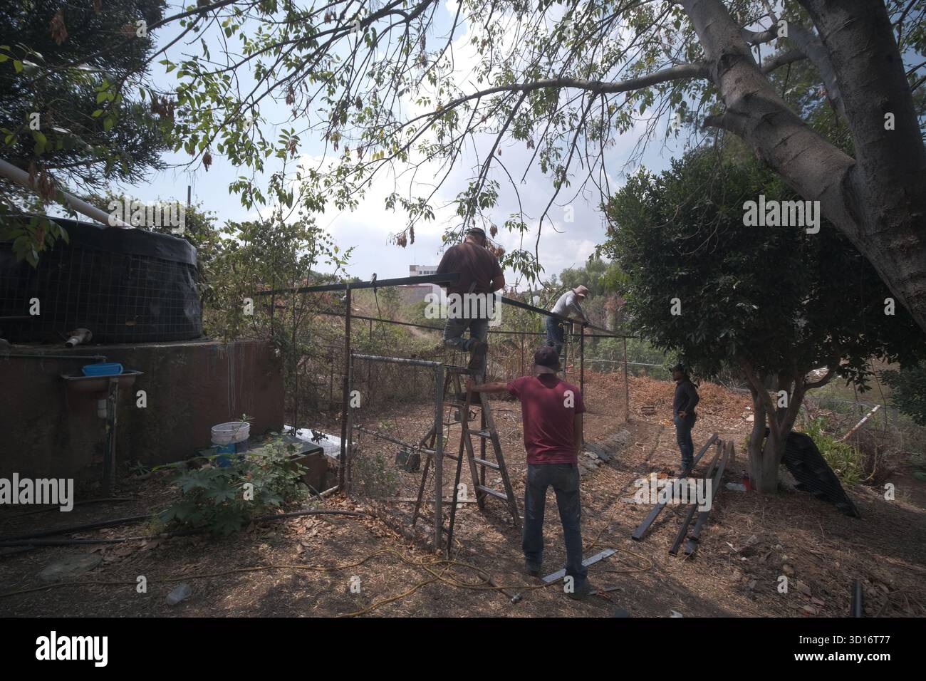 Blacksmiths working outdoors on a very simple structure Stock Photo