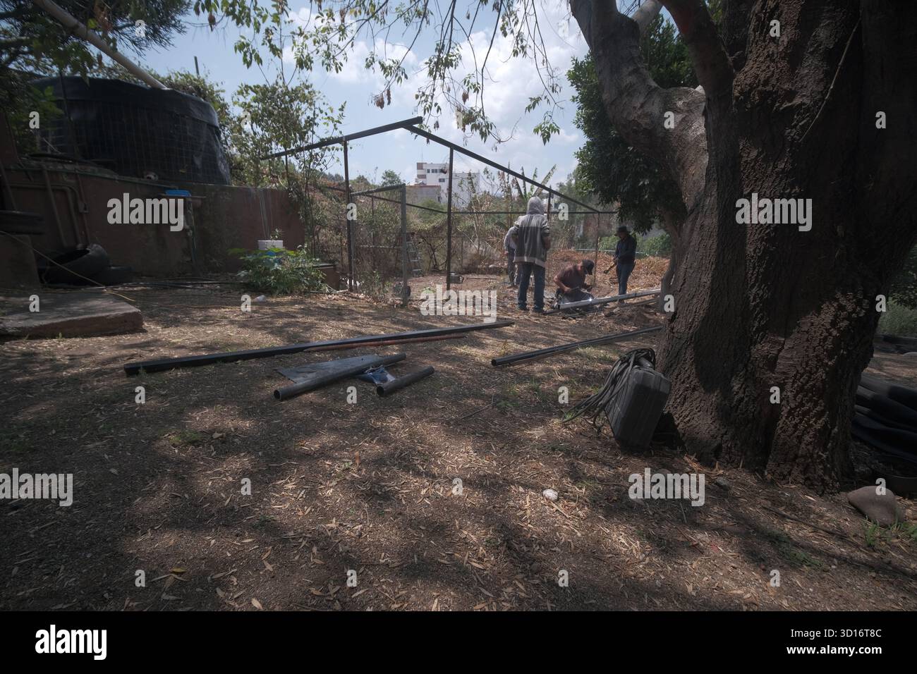 Blacksmiths working outdoors on a very simple structure Stock Photo