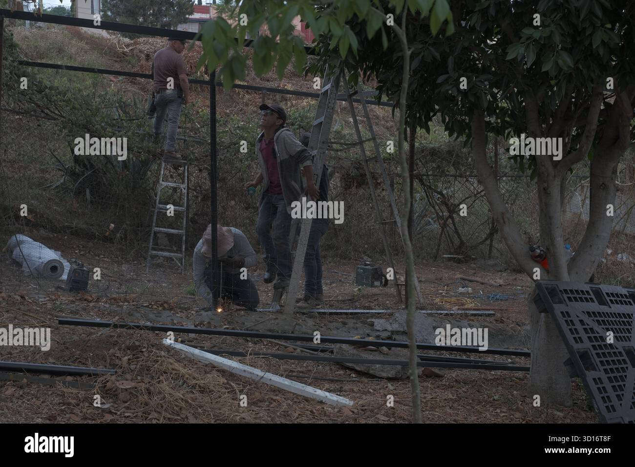 Blacksmiths working outdoors on a very simple structure Stock Photo