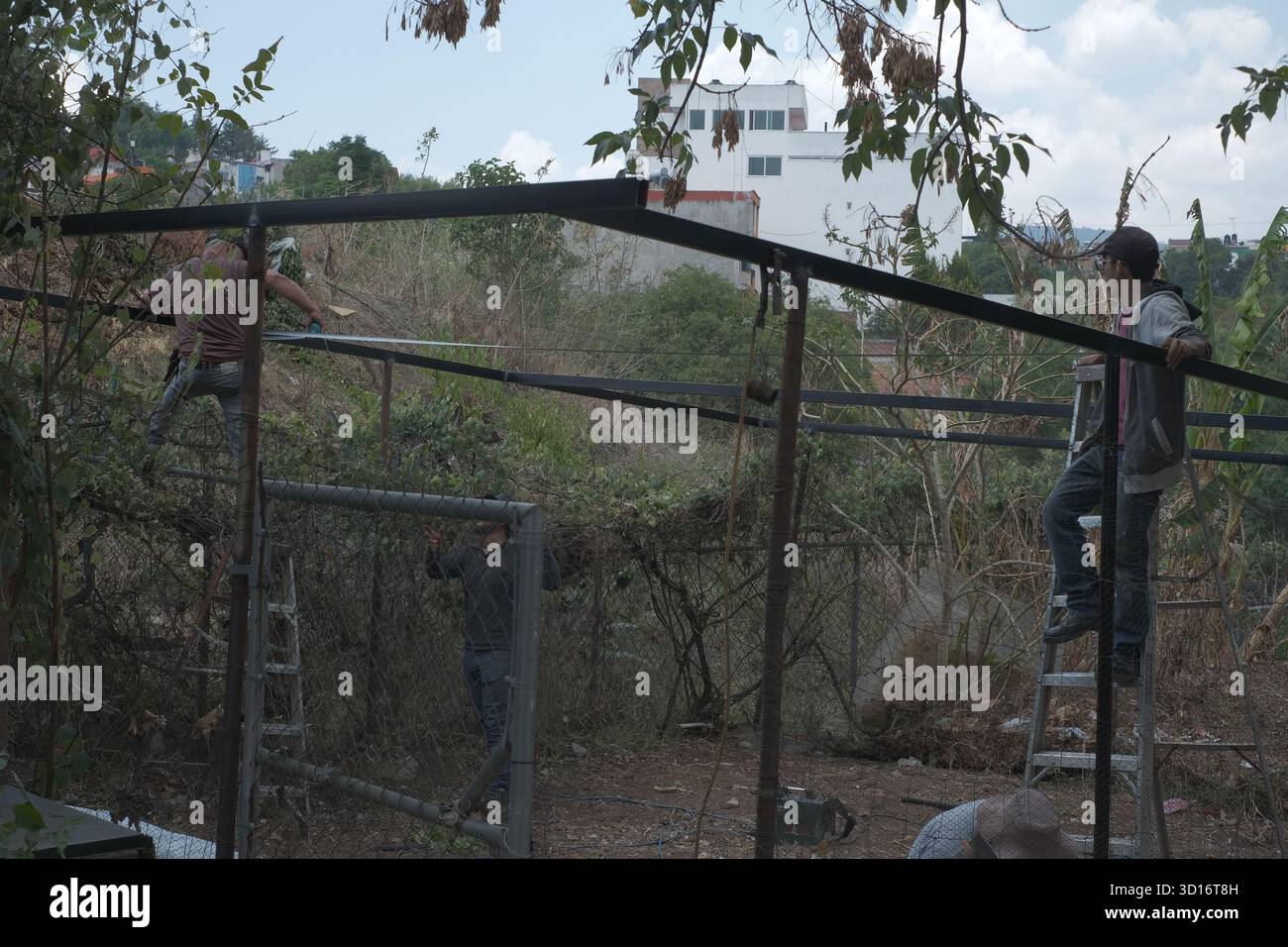 Blacksmiths working outdoors on a very simple structure Stock Photo