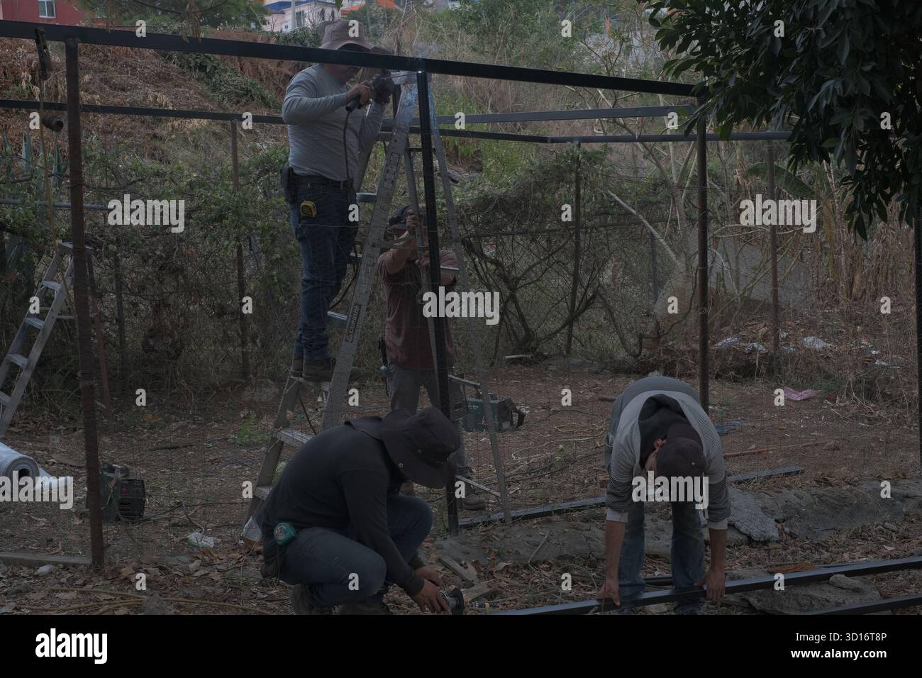 Blacksmiths working outdoors on a very simple structure Stock Photo