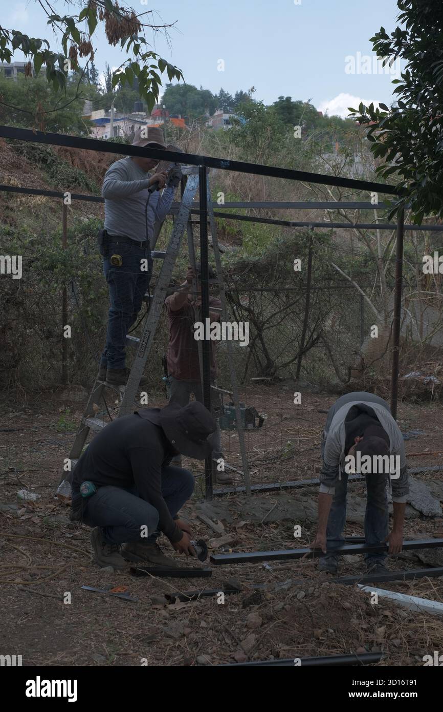 Blacksmiths working outdoors on a very simple structure Stock Photo