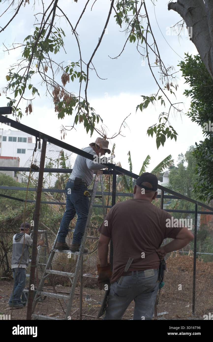 Blacksmiths working outdoors on a very simple structure Stock Photo