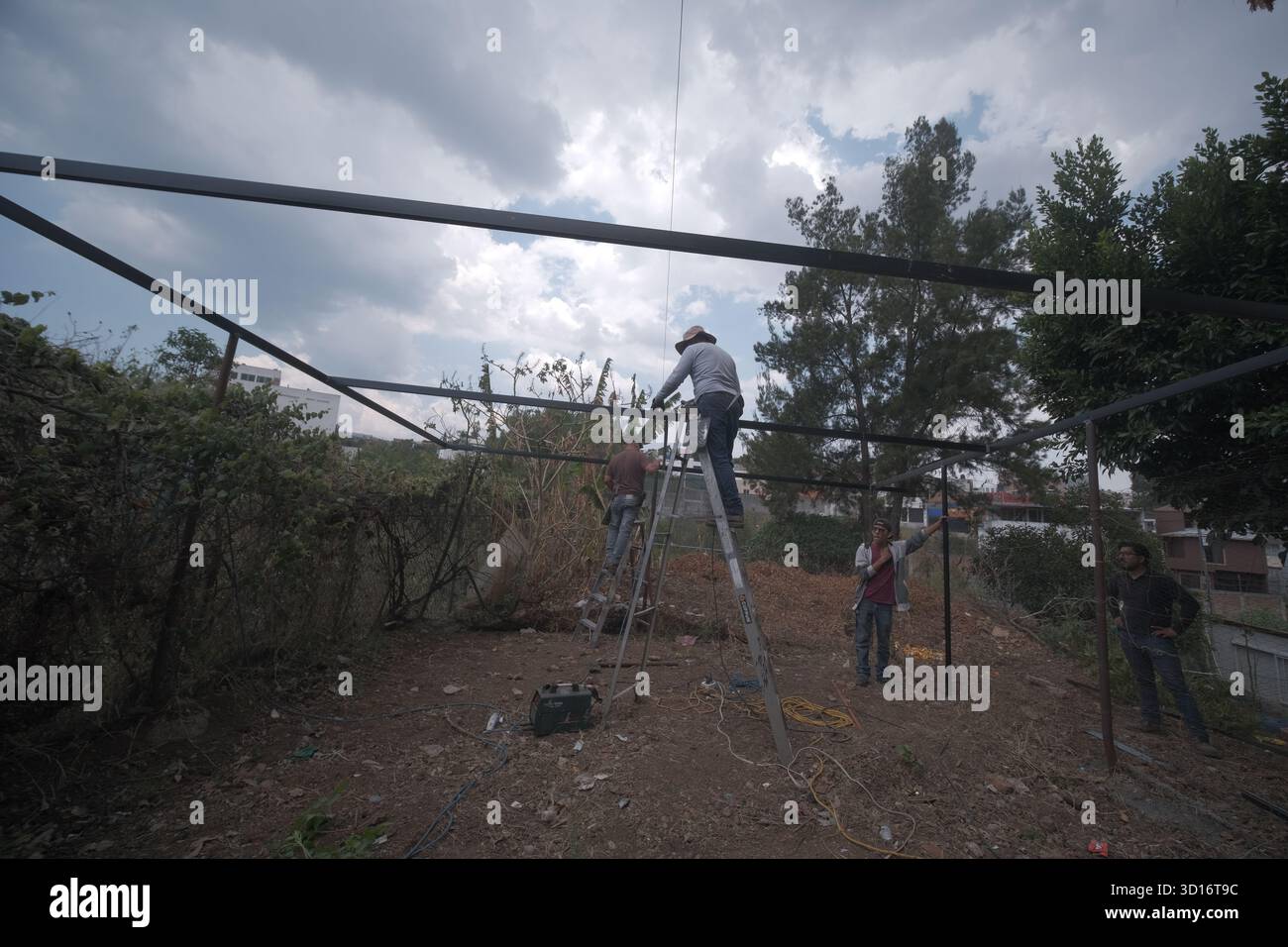 Blacksmiths working outdoors on a very simple structure Stock Photo