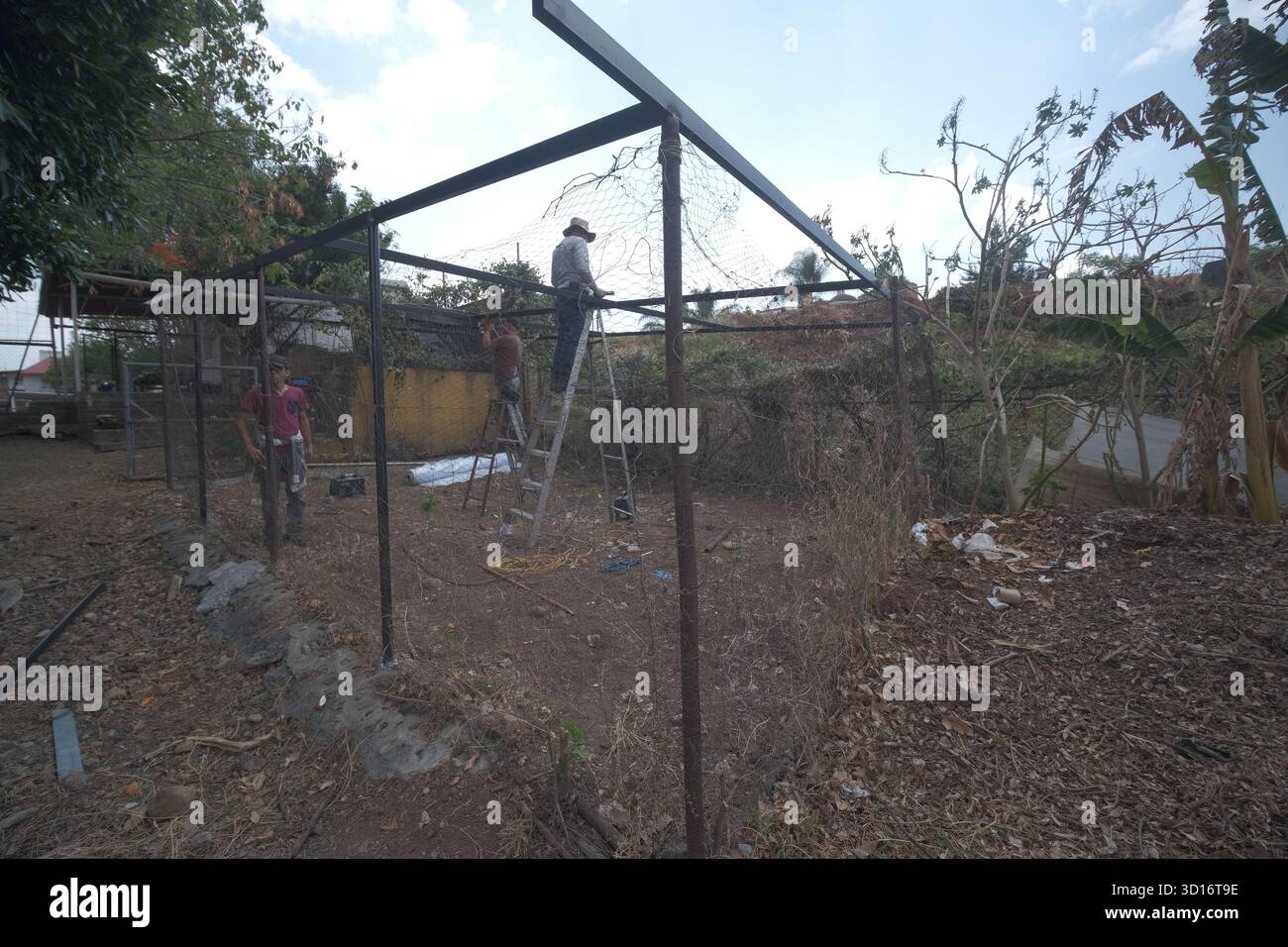 Blacksmiths working outdoors on a very simple structure Stock Photo