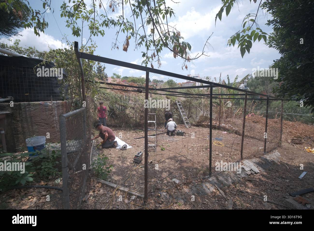 Blacksmiths working outdoors on a very simple structure Stock Photo