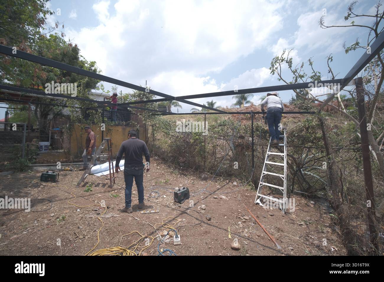 Blacksmiths working outdoors on a very simple structure Stock Photo