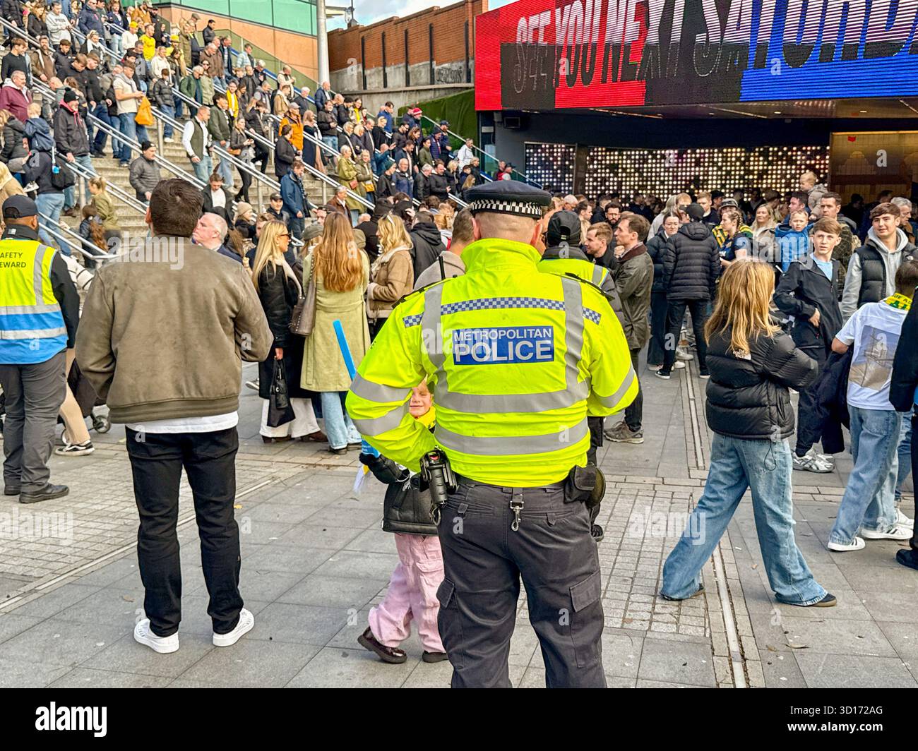 London, England, UK - 25 October 2025: Police officers from the Metropolitan Police on duty outside Wembley Stadium for a major sporting event - Smartphone Captured Stock Image