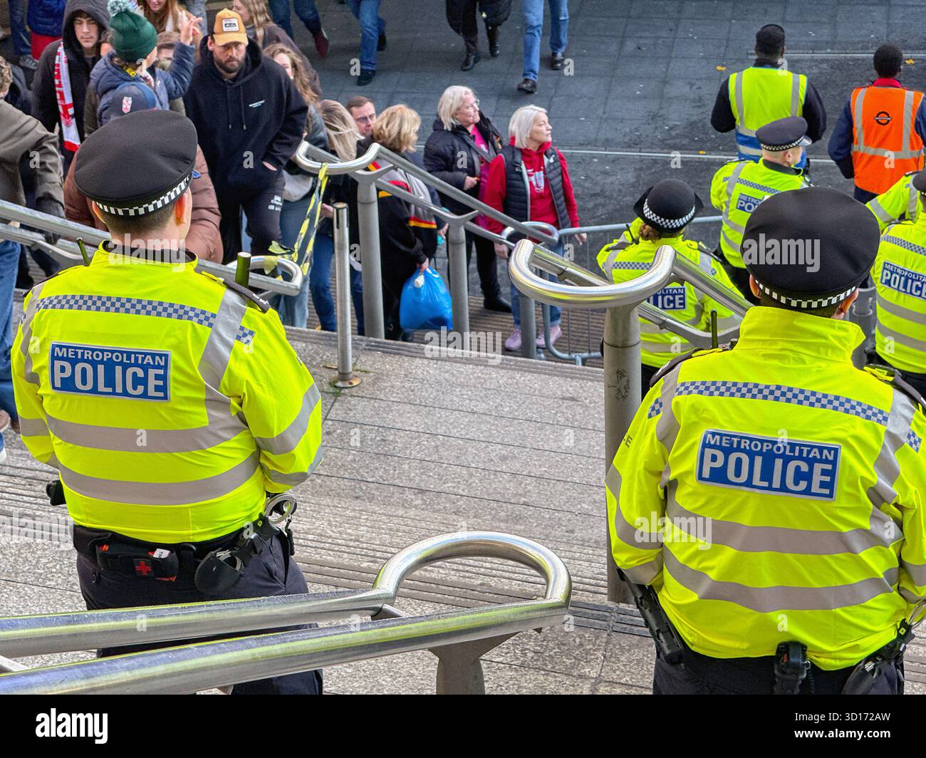 London, England, UK - 25 October 2025: Police officers from the Metropolitan Police on duty outside Wembley Stadium for a major sporting event - Smartphone Captured Stock Image