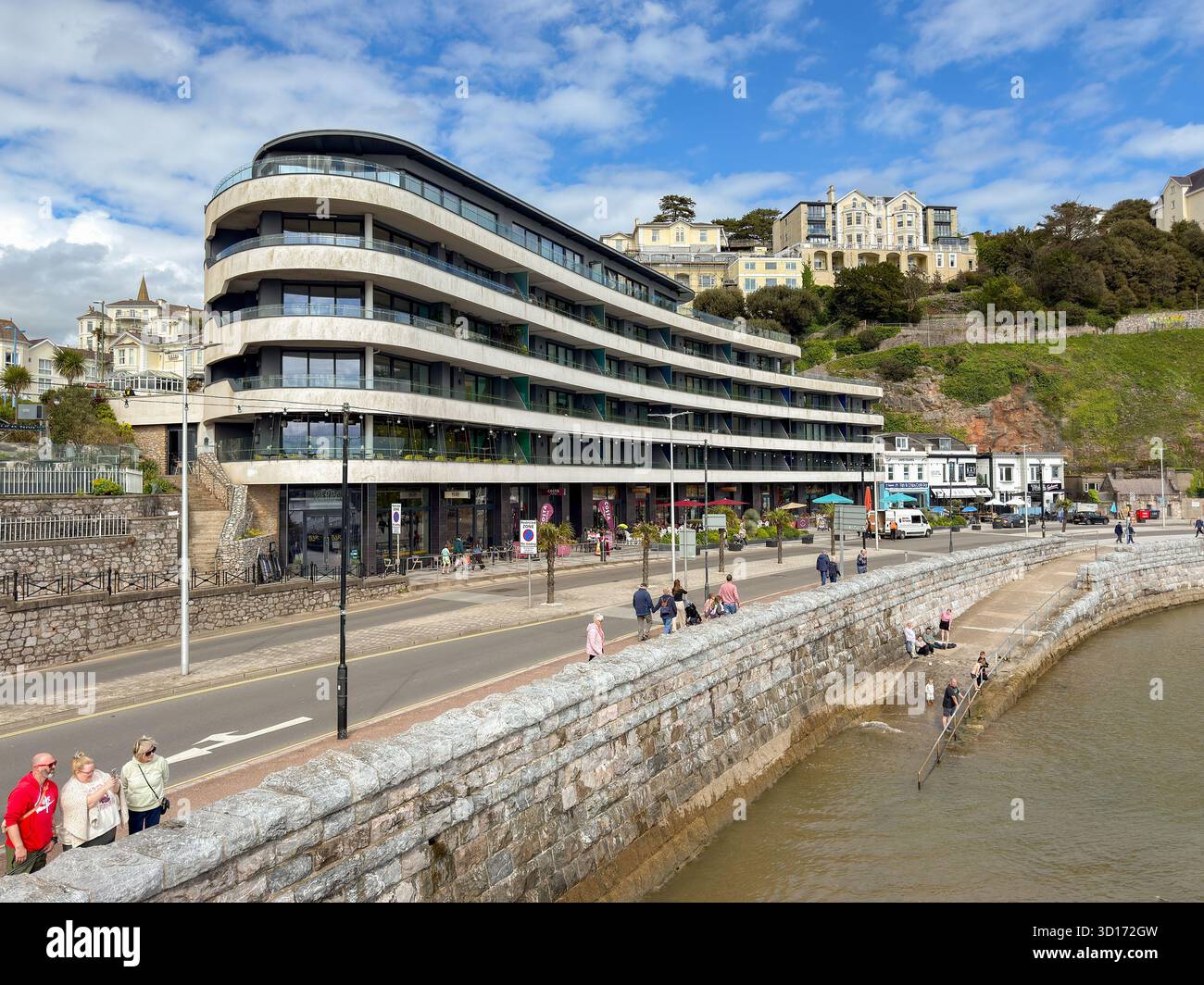 Torquay, Devon, England, UK - 23 April 2025: Modern mixed use building with apartments and restaurants on the seafront in Torquay - Smartphone Captured Stock Image
