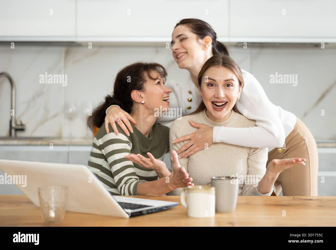Women are sitting at computer and are immensely happy Stock Photo