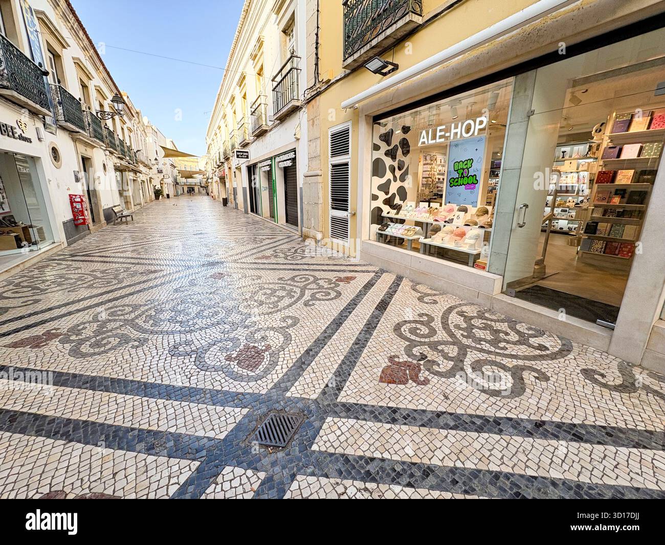 Faro, Portugal, Ale-Hop variety store and patterned tiled street in the city centre - Smartphone Captured Stock Image