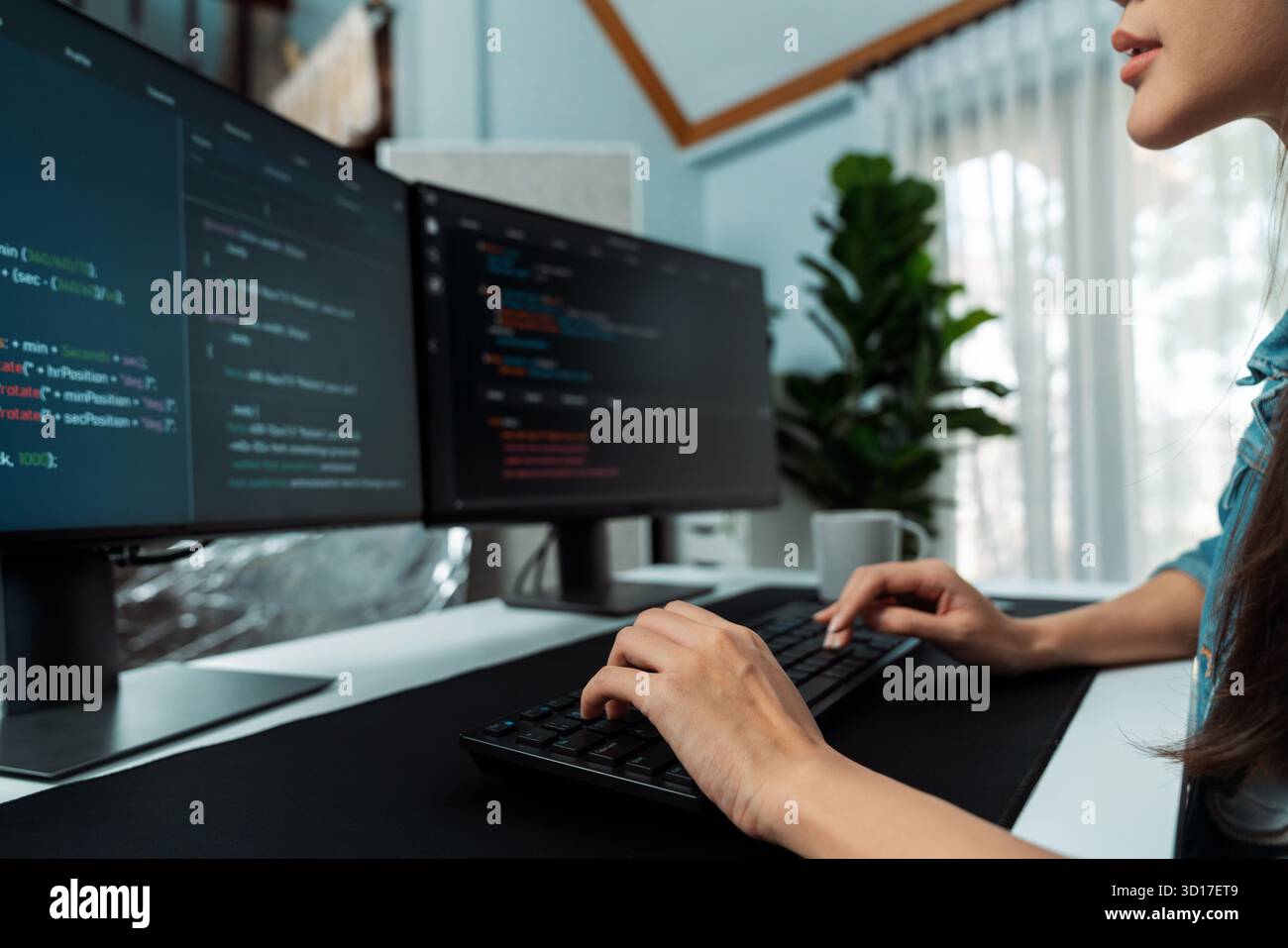 Young Asian in IT developer creating with typing online information on pc with coding program data of website application, wearing jeans shirt. surrou Stock Photo