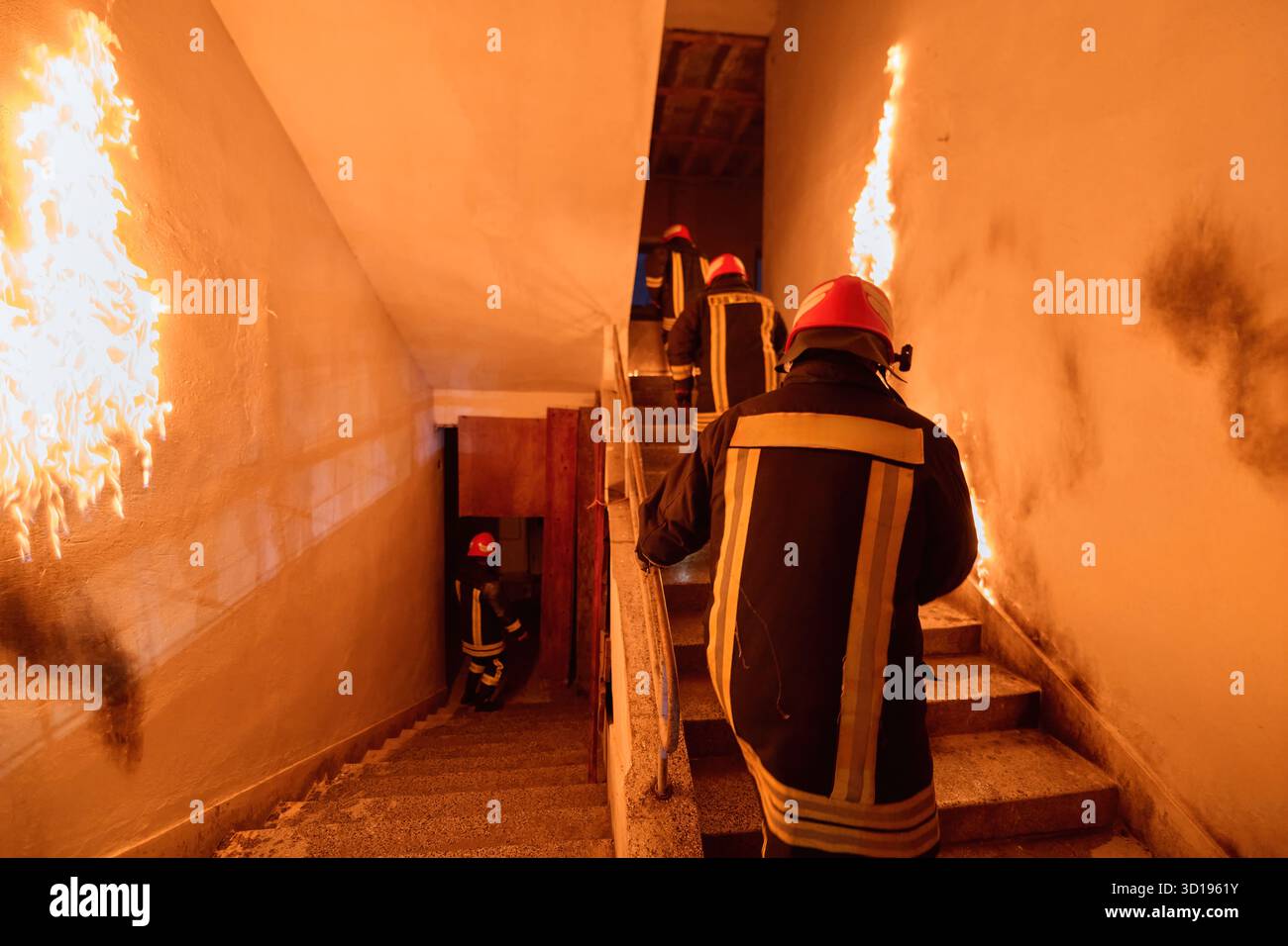 Firefighters in action, climbing stairs amidst flames and smoke ...