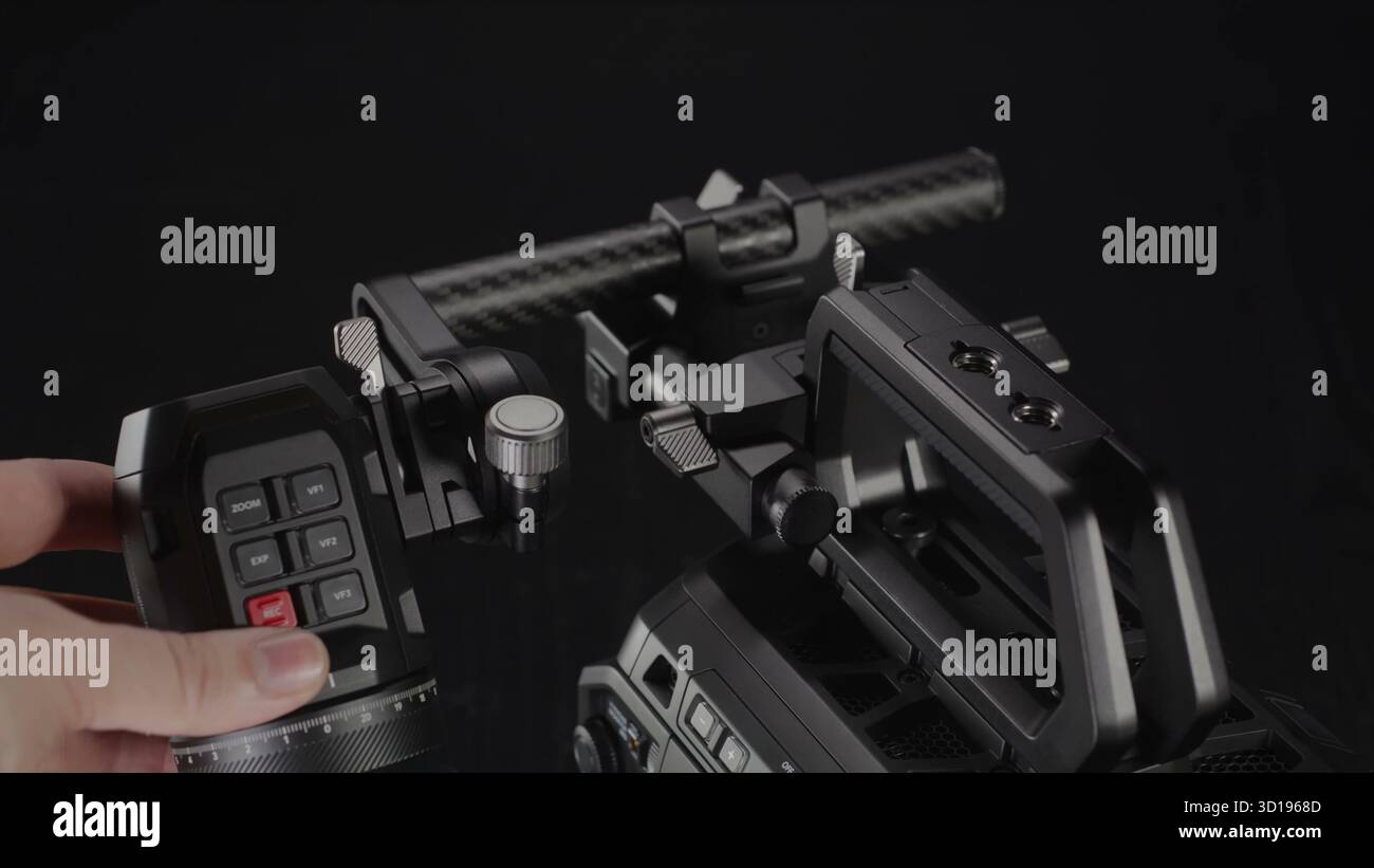 A hand activates the recording function on a professional cinema. Stock Photo