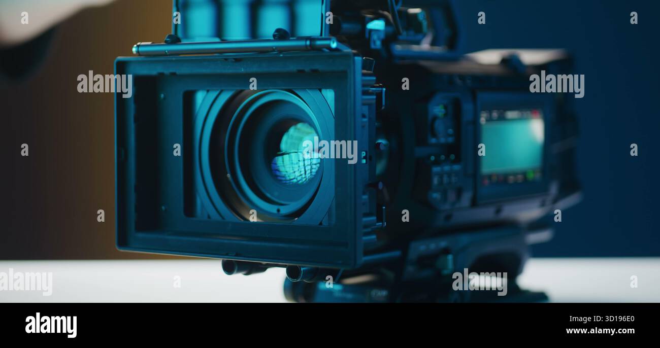 A professional camera captures moments in a cool, blue-lit studio. Stock Photo