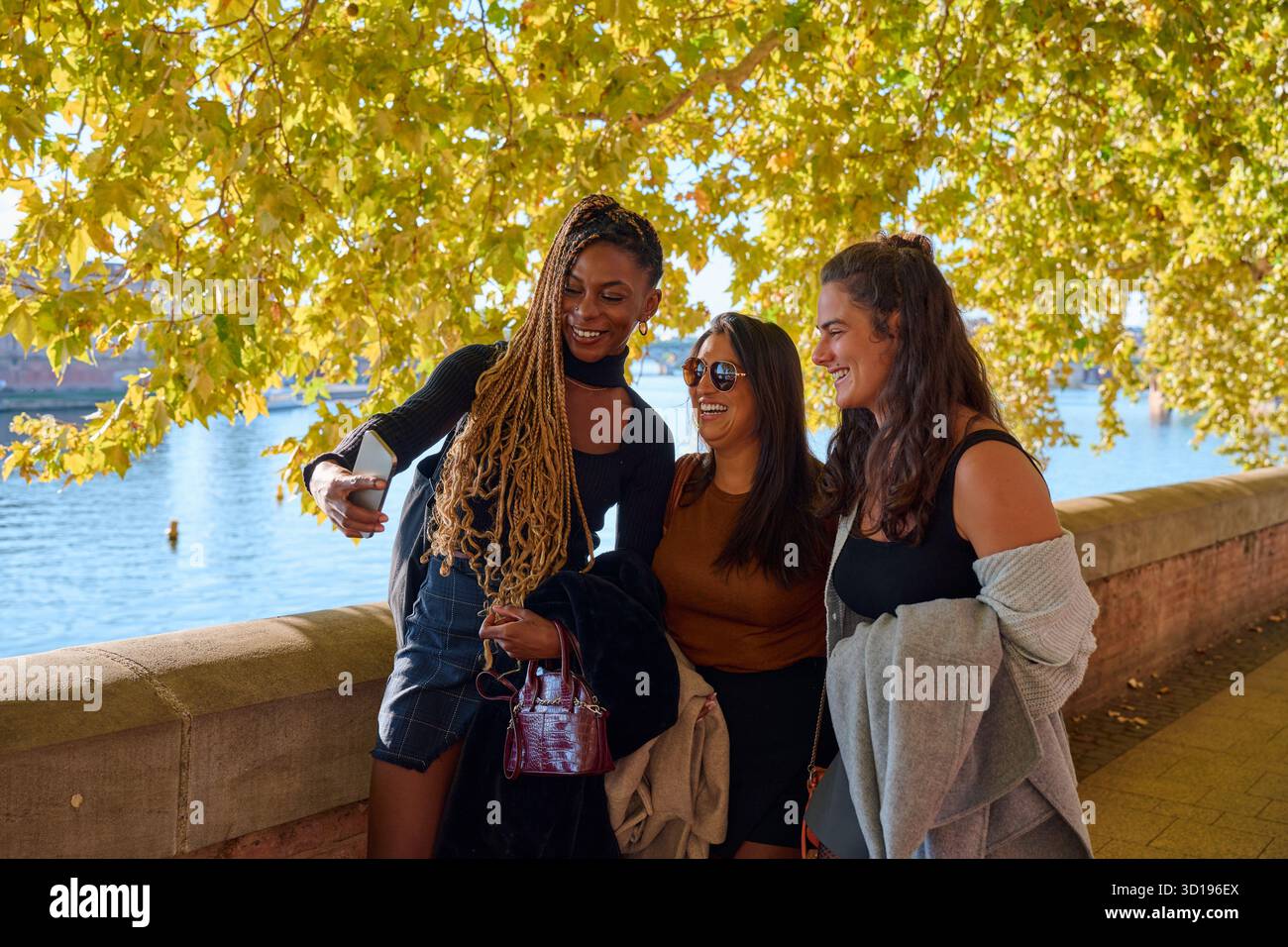 Three happy women friends taking selfie in toulouse Stock Photo