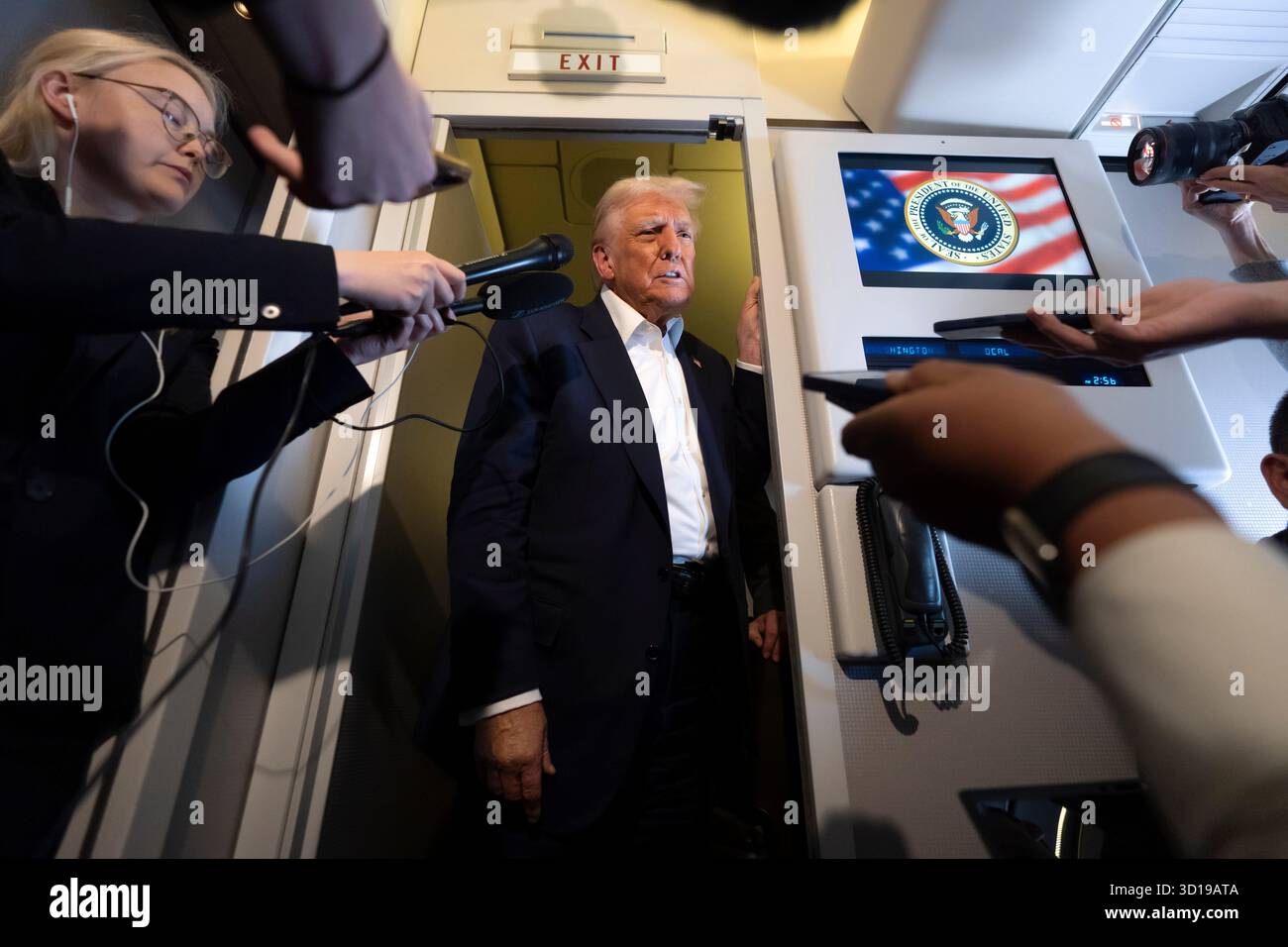 President Donald Trump speaks to reporters aboard Air Force One while ...