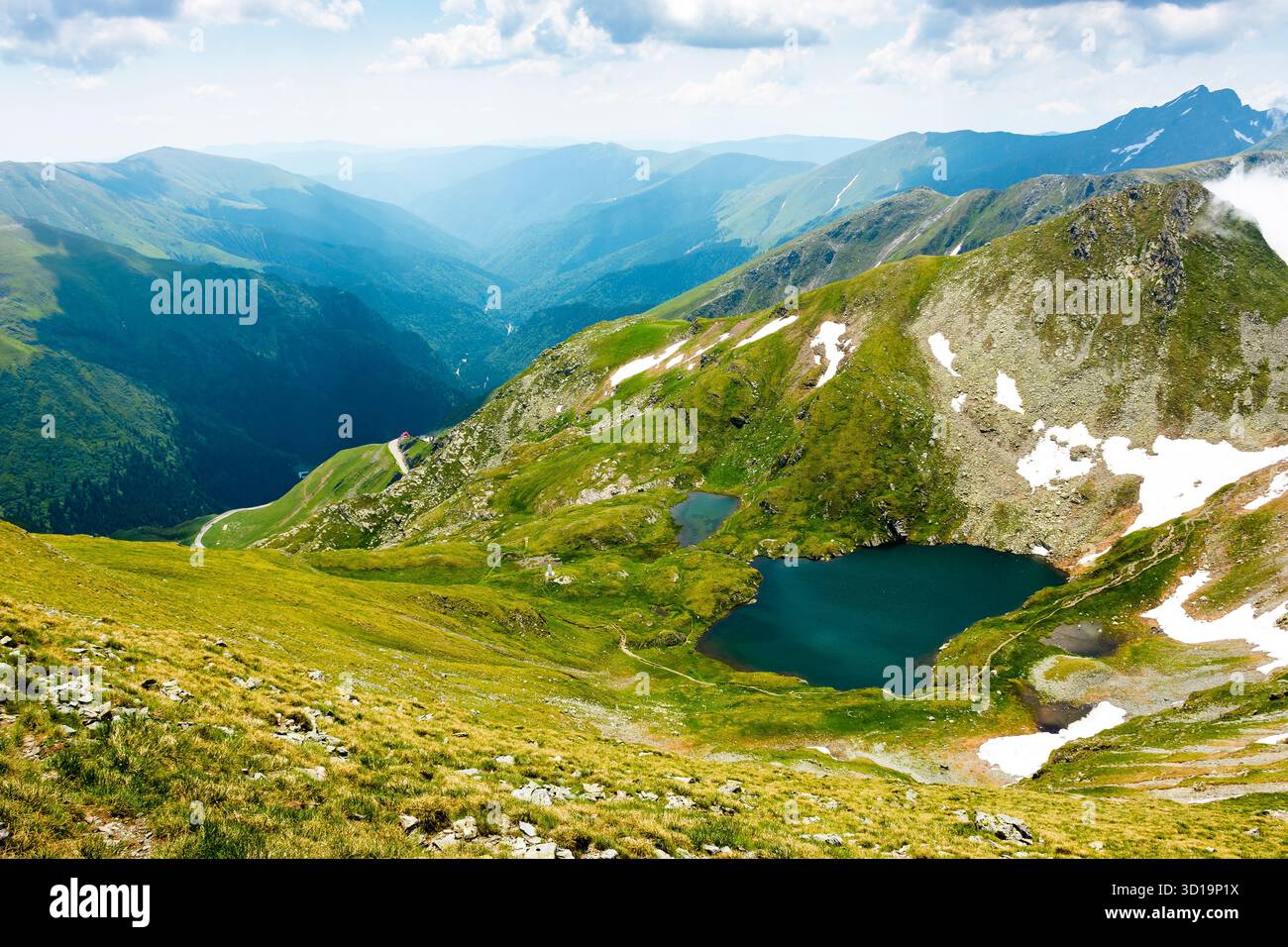 mountain landscape with alpine lake in summer. beautiful pond near popular hiking trail through transylvania alps of fagaras massif. postcard from rom Stock Photo