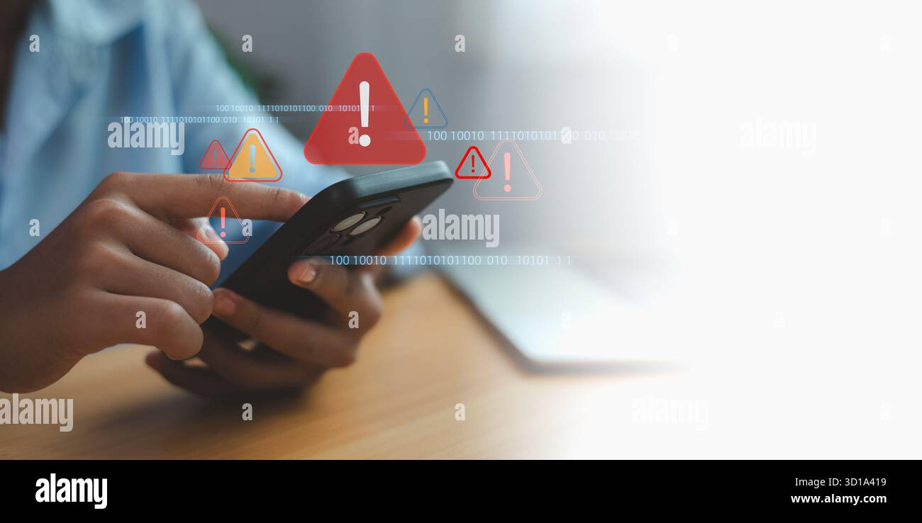 Person holding smartphone with digital warning alerts and binary code background, representing data breach, cybersecurity threat, and mobile security Stock Photo
