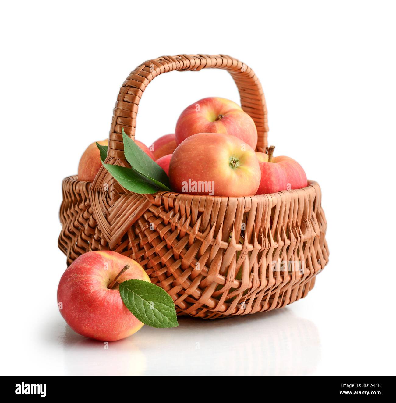 Ripe apples in a wicker basket isolated  on white  background Stock Photo