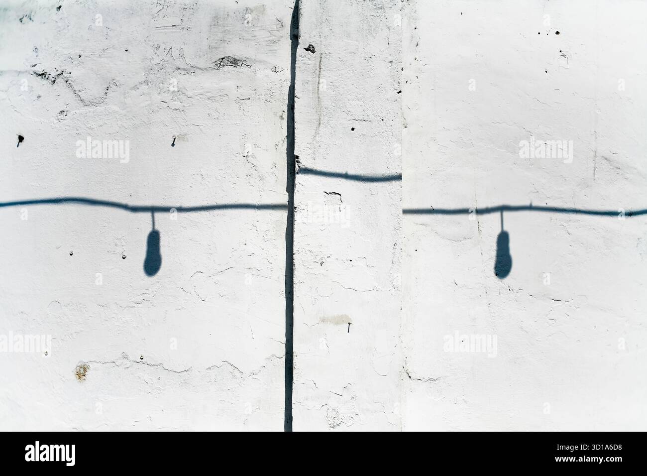 shadow of lighbulb with cable on white grunge wall Stock Photo