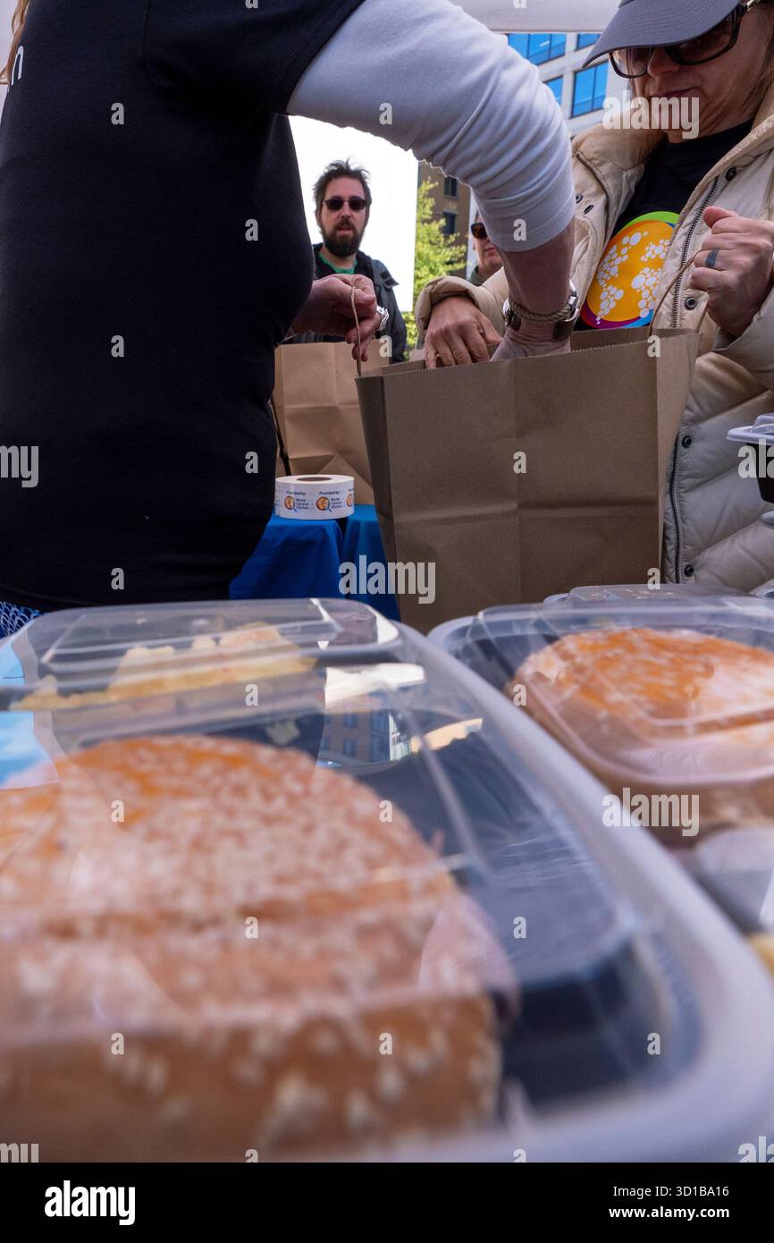 Workers with chef Jose Andres' World Central Kitchen load a bag with ...