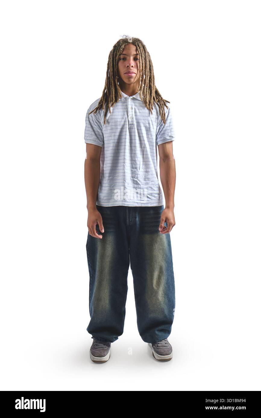 Young man with long dreadlocks and serious expression posing in a studio Stock Photo