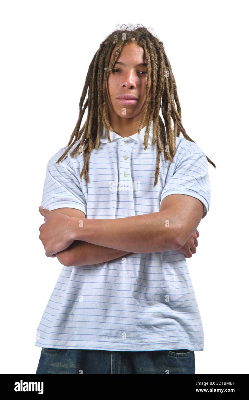 Young man with long dreadlocks and serious expression posing in a studio Stock Photo