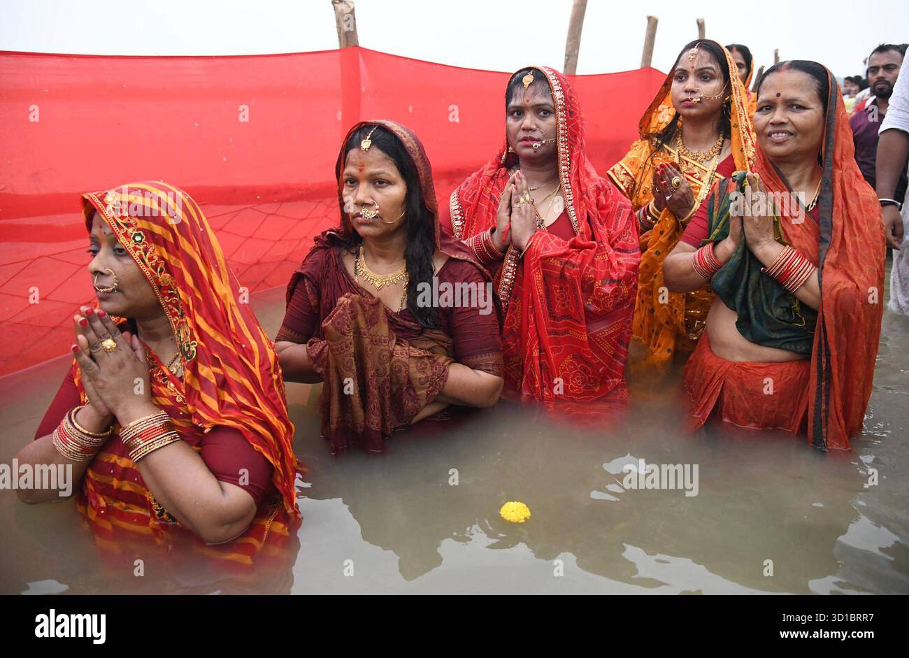 PATNA, INDIA - OCTOBER 27: Chhath devotees perform rituals in the Ganga ...