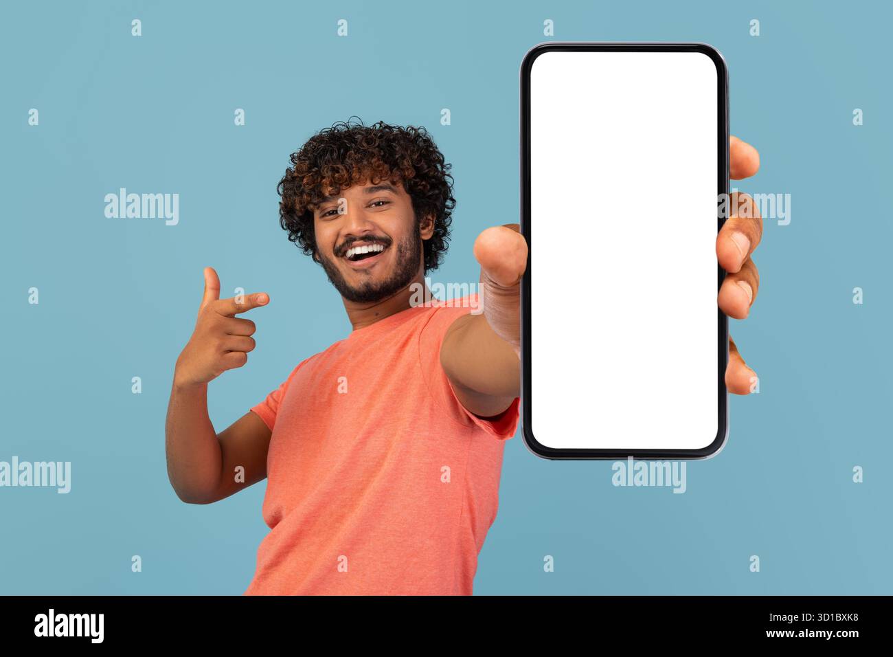 Cool Young Indian Guy Shows Empty Cell Phone Screen While Sharing Exciting Deal Stock Photo