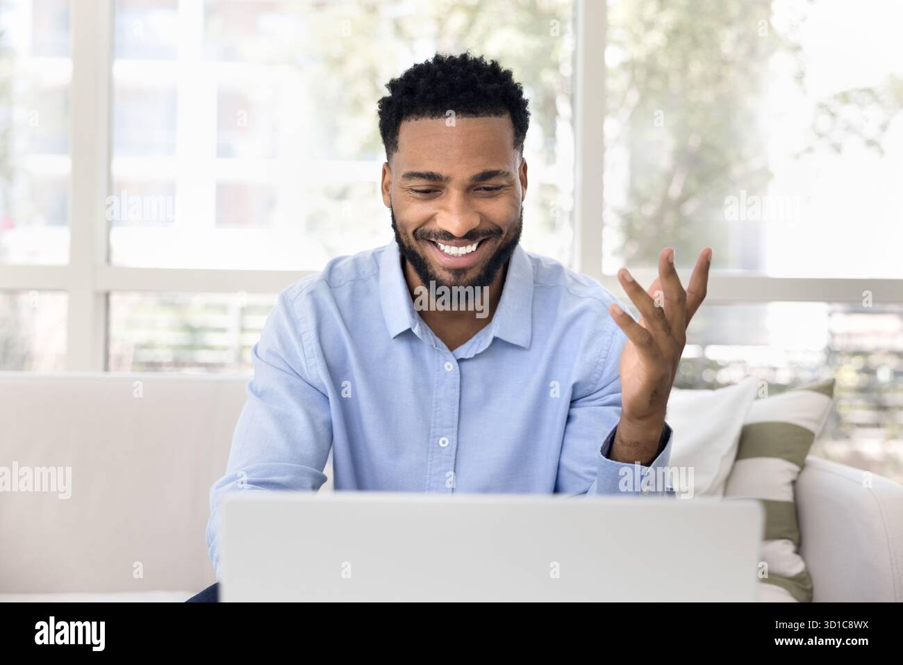 Handsome African man using laptop at home Stock Photo