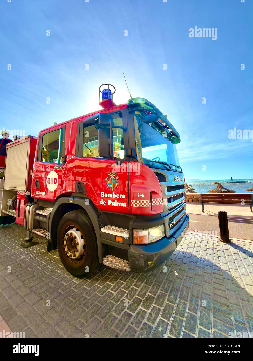 Red fire truck belonging to Bombers de Palma parked near  seaside promenade on a clear day in Can Pastilla Mallorca - Smartphone Captured Stock Image