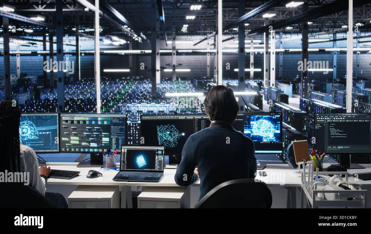 Programmer entering server room office, using AI to review infrastructure diagnostics. IT admin in data center high tech facility analyzes performance data using artificial intelligence tech, camera A Stock Photo