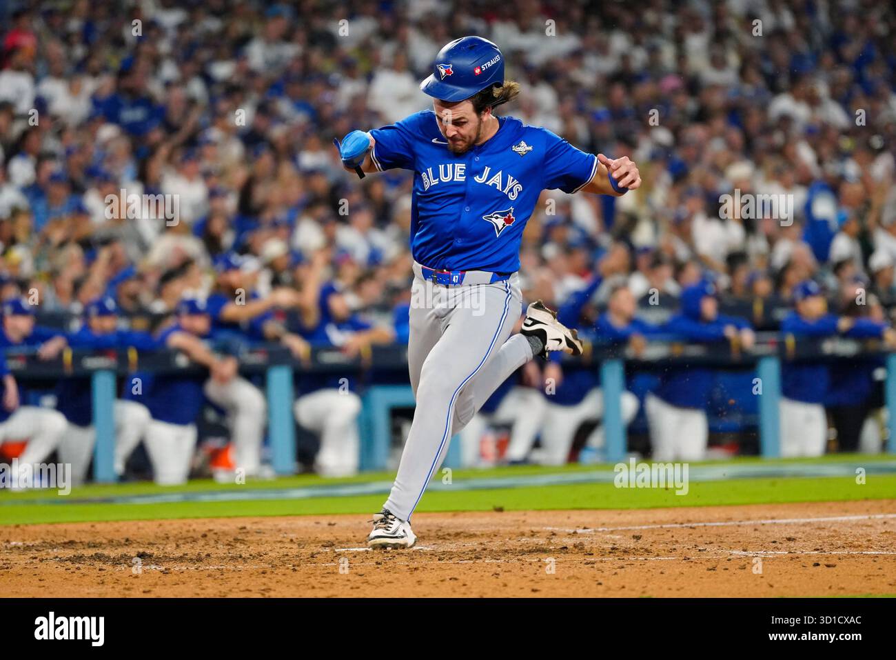 Toronto Blue Jays' Addison Barger (47) loses his helmet as he scores on ...