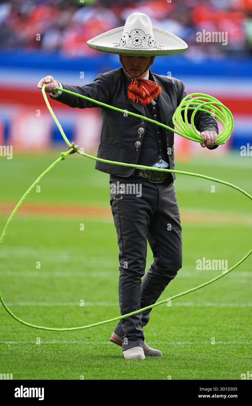 A performer carries out a trick rope act during halftime of an NFL ...