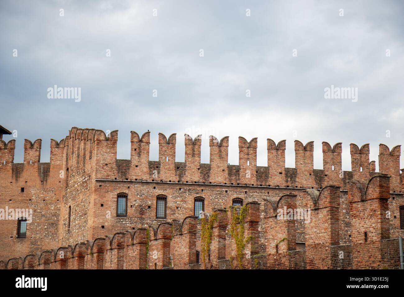 Swallowtail battlements or merlons and red brickwork of Castelvecchio ...